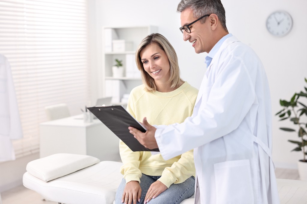 Doctor reviewing results with a patient in a bright medical office